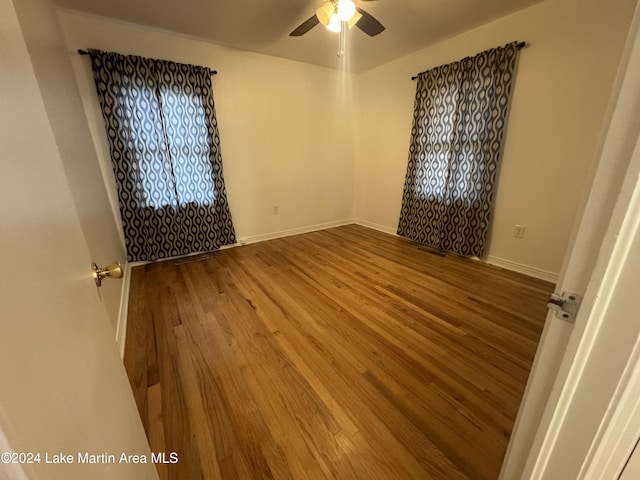 spare room featuring hardwood / wood-style flooring and ceiling fan