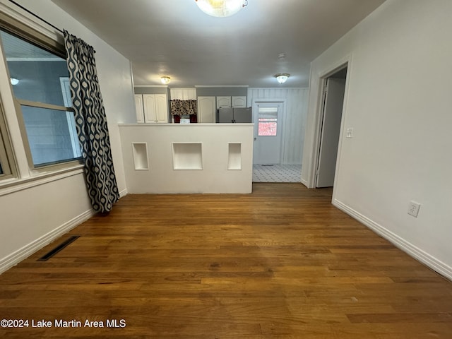 unfurnished room with wood-type flooring