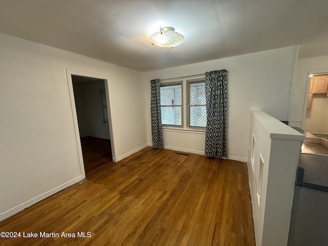 spare room with dark hardwood / wood-style floors