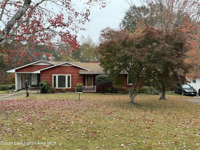 ranch-style house with a front yard and a carport