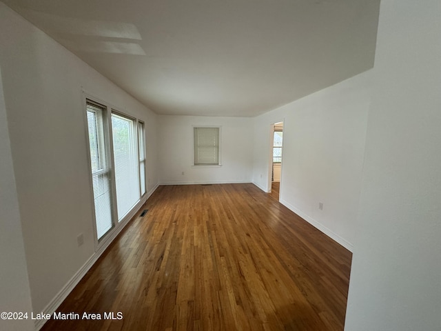 unfurnished living room with dark hardwood / wood-style floors