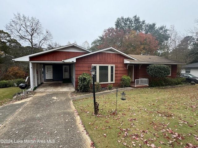 view of front of property with a front lawn and a carport