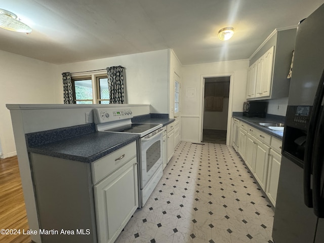 kitchen with white cabinetry, stainless steel fridge with ice dispenser, sink, and white electric range oven