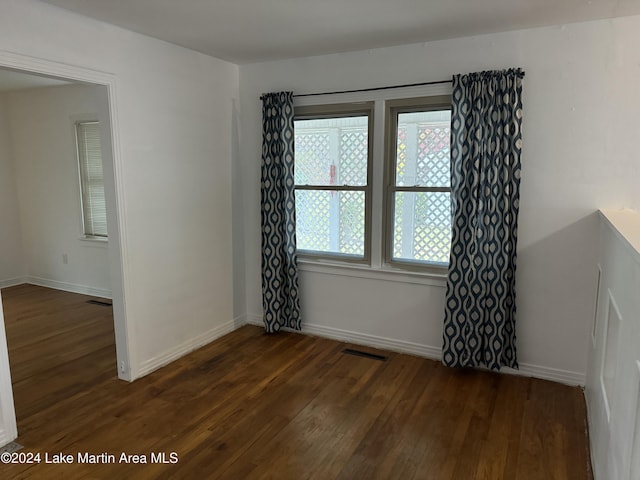 spare room with dark wood-type flooring