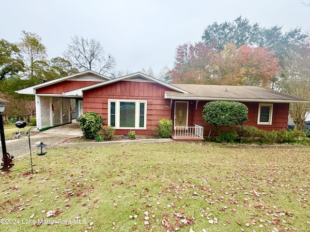 view of front of property with a front yard and a carport