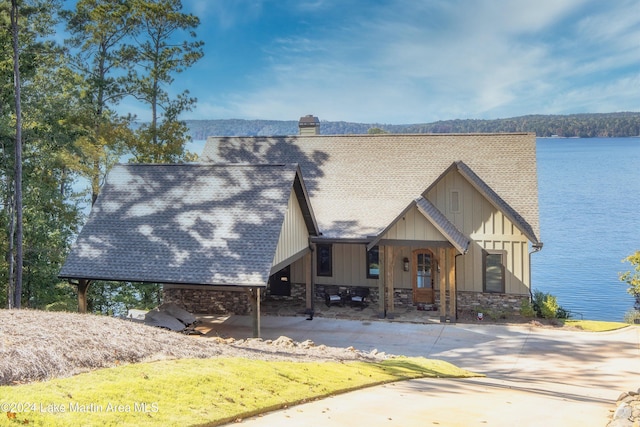 view of front of house featuring a water view and a carport