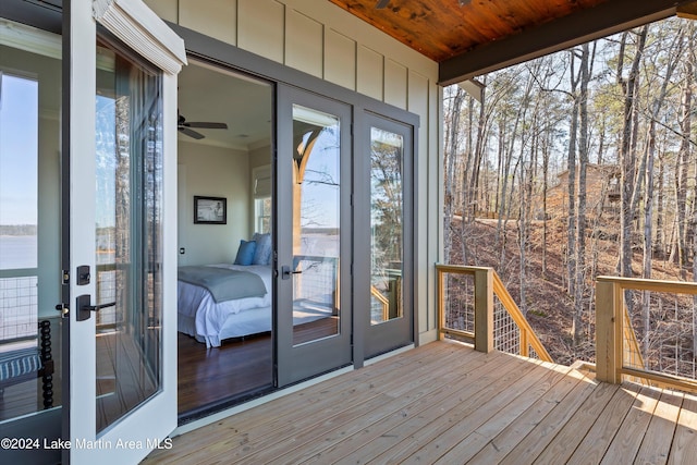 unfurnished sunroom featuring ceiling fan and wood ceiling