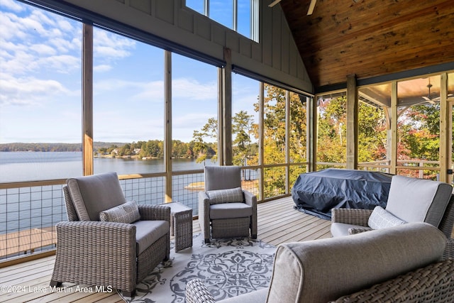 sunroom / solarium with a water view and vaulted ceiling