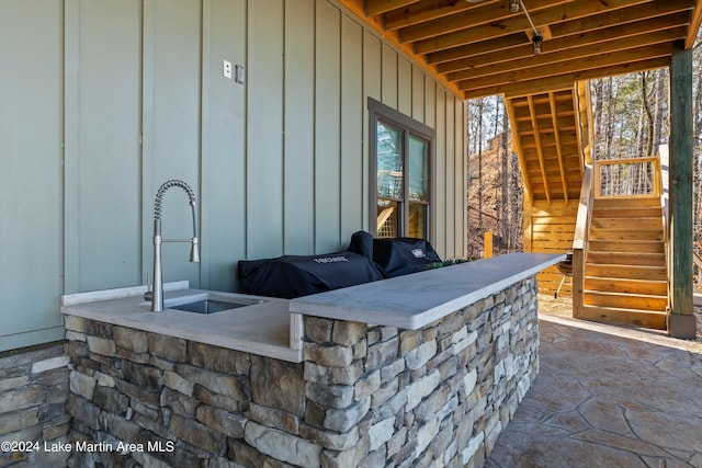 view of patio with an outdoor wet bar