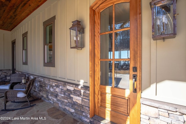 view of exterior entry featuring covered porch