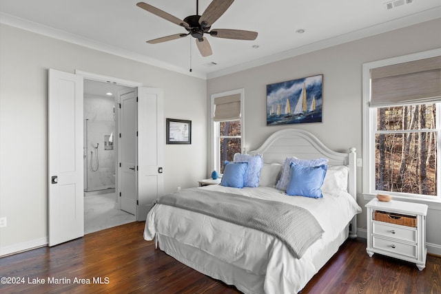 bedroom featuring ceiling fan, ensuite bath, crown molding, and dark wood-type flooring