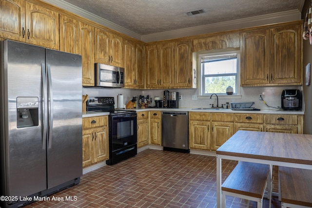 kitchen featuring stainless steel appliances, tasteful backsplash, a textured ceiling, ornamental molding, and sink