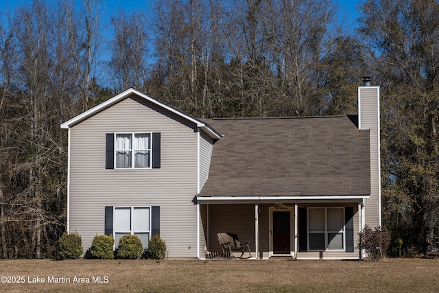 back of property featuring a lawn