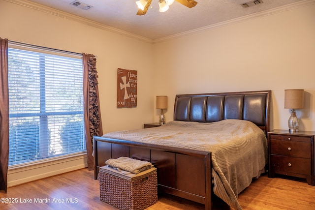 bedroom featuring ceiling fan, ornamental molding, and light hardwood / wood-style floors