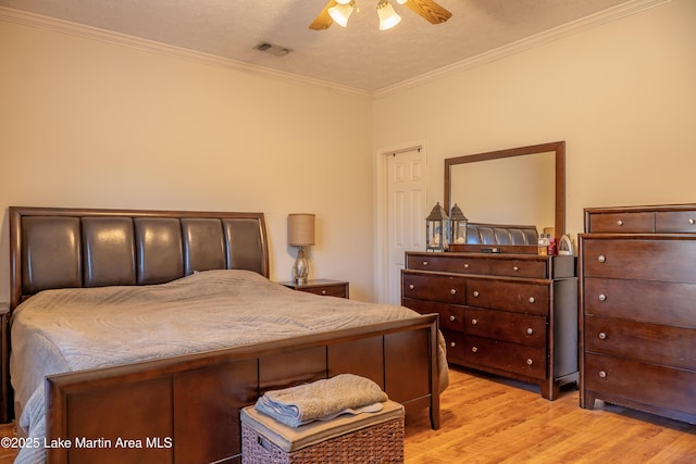 bedroom featuring a textured ceiling, ceiling fan, and crown molding