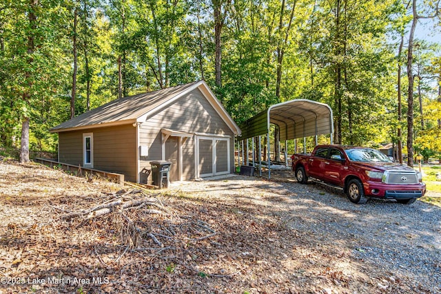 view of outdoor structure with a carport and a garage