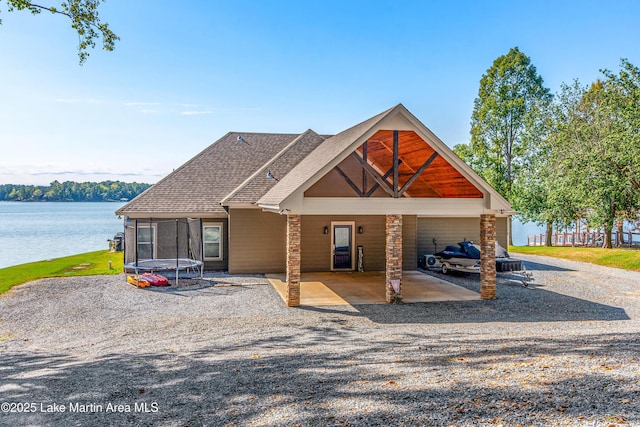 view of front of property featuring a water view and a trampoline