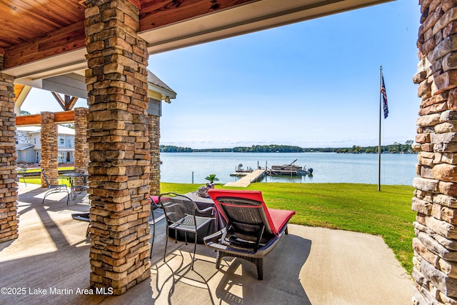 view of patio with a boat dock and a water view