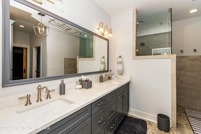 bathroom with vanity and a tile shower