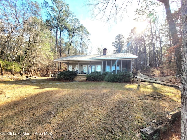 back of house featuring a porch and a lawn