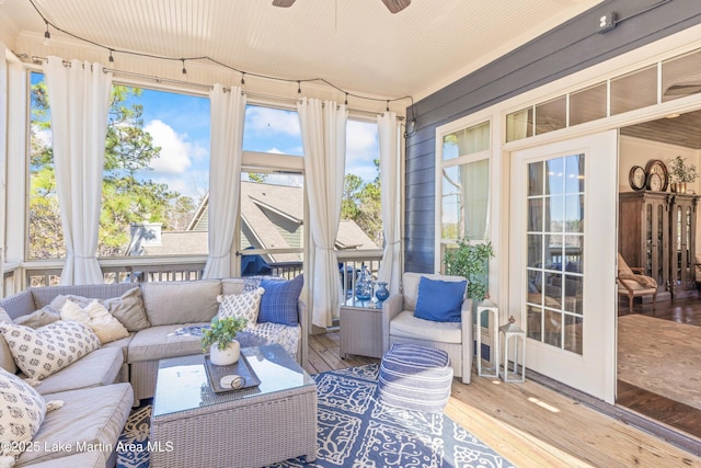 sunroom / solarium featuring ceiling fan