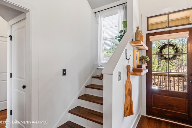 stairs featuring hardwood / wood-style flooring