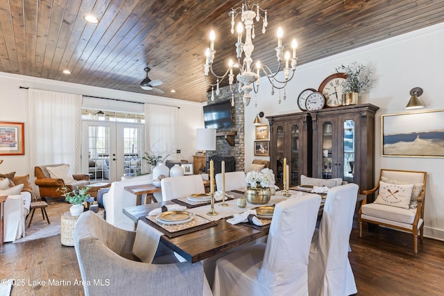 dining space featuring a fireplace, dark wood-type flooring, wood ceiling, and french doors