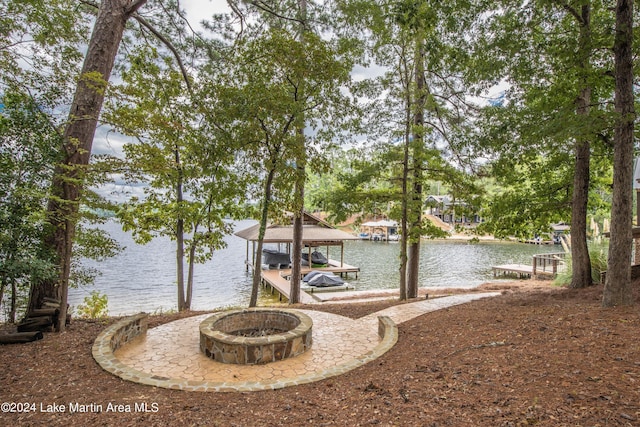 dock area featuring a water view and an outdoor fire pit