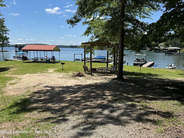 view of yard featuring a boat dock and a water view