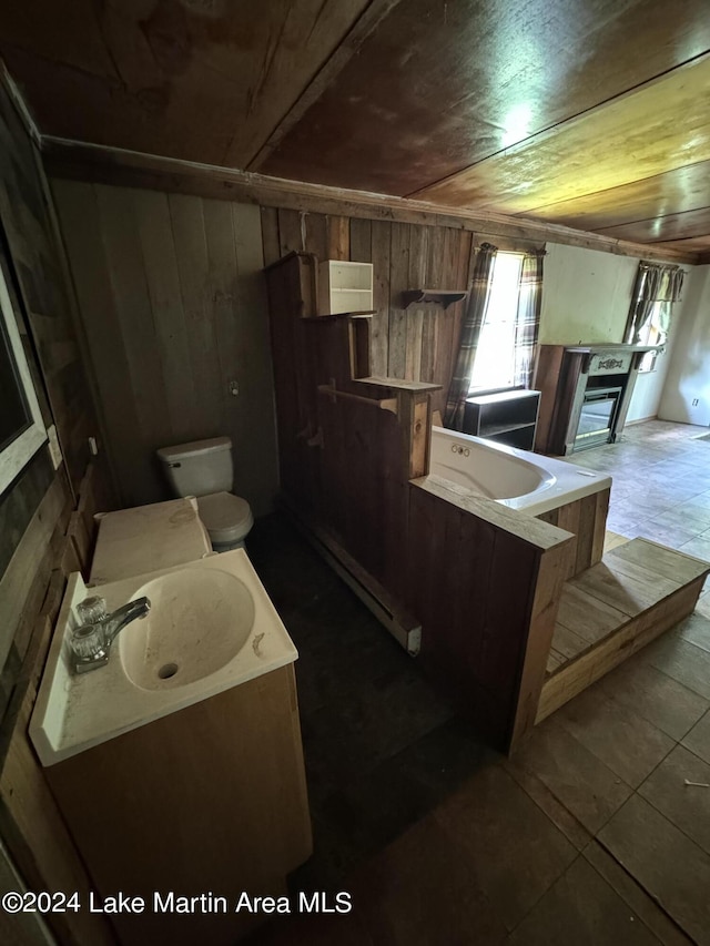 kitchen with wood walls, sink, and dark tile patterned flooring