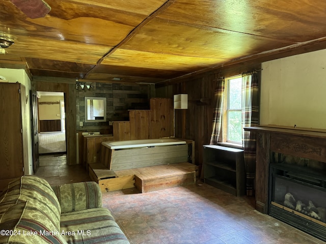 living room with wood walls and wooden ceiling