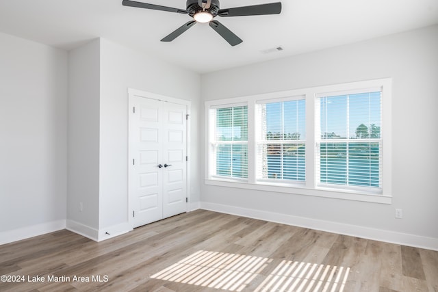 spare room with light hardwood / wood-style floors and ceiling fan