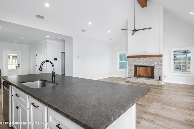 kitchen with white cabinetry, plenty of natural light, and high vaulted ceiling