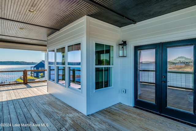 wooden deck with french doors and a water view