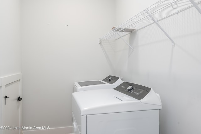 clothes washing area featuring washer and dryer