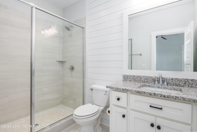 bathroom with toilet, vanity, and walk in shower