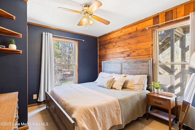 1449 Seals St, Auburn, AL 36879 - carpeted bedroom featuring a textured ceiling, a ceiling fan, and wooden walls