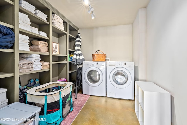 laundry room featuring independent washer and dryer and track lighting