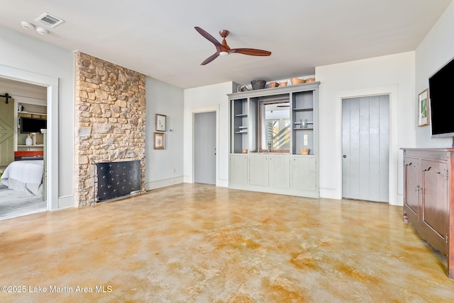 living room featuring ceiling fan and a fireplace