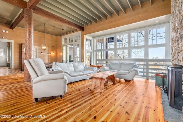 living room with beam ceiling and light hardwood / wood-style flooring