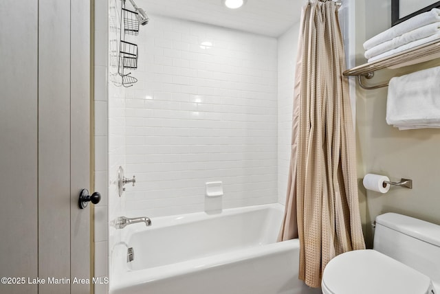 bathroom featuring toilet and shower / bath combo