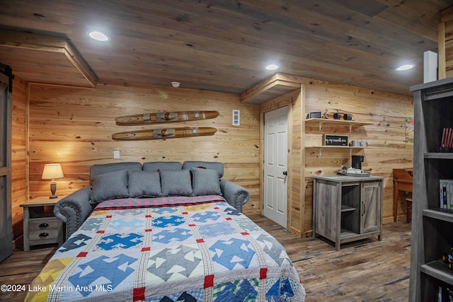 bedroom featuring wooden walls and dark hardwood / wood-style floors