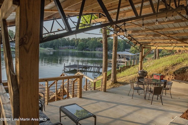 view of patio / terrace featuring a water view and a dock