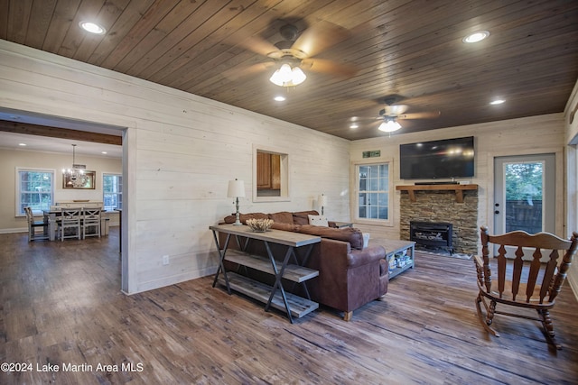 living room featuring wooden ceiling, wooden walls, ceiling fan, and dark wood-type flooring