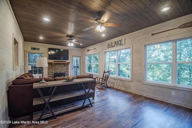 living room featuring wood walls, hardwood / wood-style floors, ceiling fan, and wood ceiling