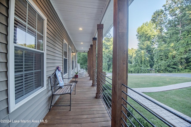 deck with covered porch and a yard