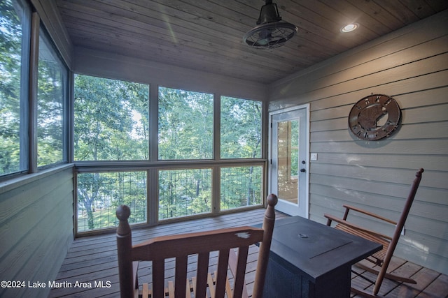 sunroom with plenty of natural light and wood ceiling