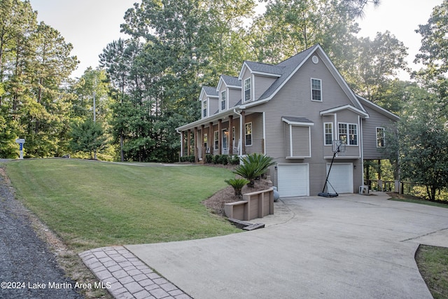 view of home's exterior featuring a yard, covered porch, and a garage