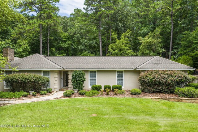 970 Raintree Dr, Alexander City, AL 35010 - single story home with a shingled roof, a chimney, a front yard, and stucco siding