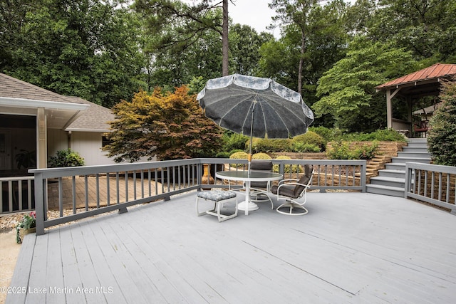 970 Raintree Dr, Alexander City, AL 35010 - wooden terrace featuring stairway, view of wooded area, outdoor dining space, and a gazebo